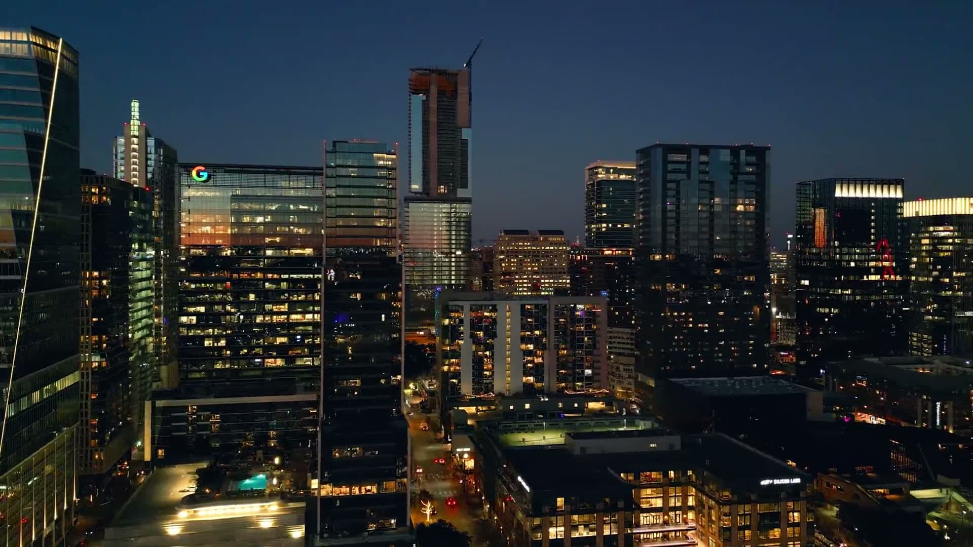 Aerial view of a financial-district skyline at golden hour